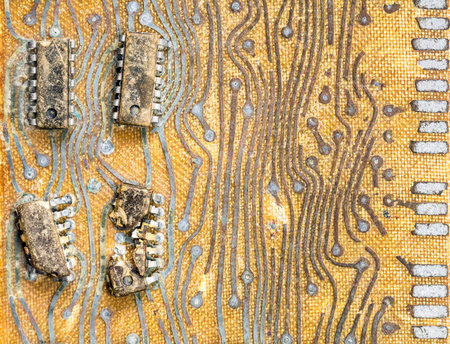 Old controller pci circuit board from computer. Strong and evident defect microchips on background of the old circuit board surfaceの写真素材