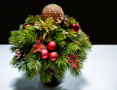 Decorated Christma small fir tree in the New Year on the tableの写真素材