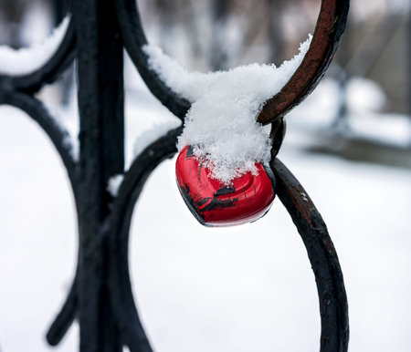 Wedding castle in the form of heart shape, attached to the fencing of the river bridge in winter timeの写真素材