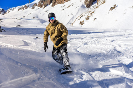 Freerider snowboarder moving down in snow powder 