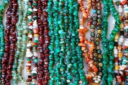 Beautiful decoration from beads of natural colored stones on market closeupの写真素材