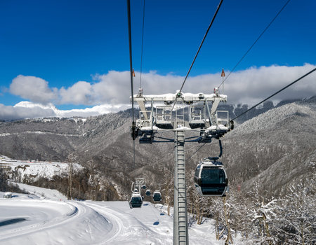 Cabin of cableway in motion closeup on rise or descent on background beautiful landscape of snowy...