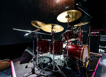 Set of drums and microphones with sound portal on the stage before the concertの写真素材