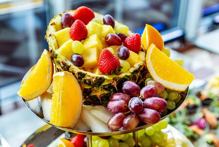 Buffet of ripe fruits on plate close up on festive day at the eventの写真素材
