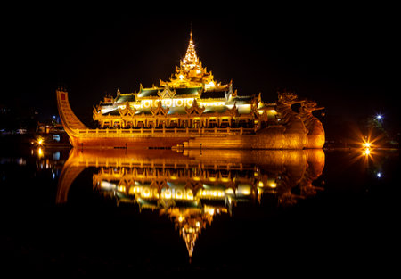 Golden Karaweik palace on the eastern shore in Kandawgyi Royal Lake at night time. Ancient royal barge. Yangon, Myanmarのeditorial素材