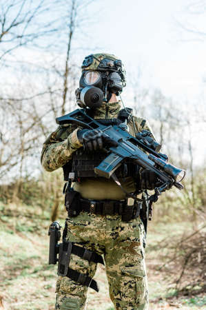 Armed soldier in Cropat pattern uniform wearing M95 Gas mask and assault rifle HK G36.の写真素材