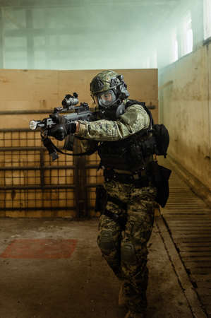 Armed soldier in Cropat pattern uniform wearing M95 Gas mask and assault rifle HK G36.の写真素材