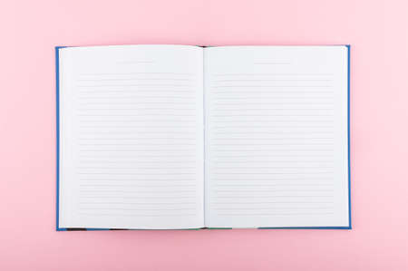 Minimal concept, notebook in flat lay style. Pink backdrop and notebook.の写真素材