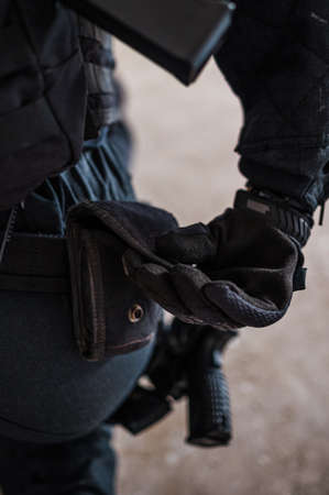 Powerful woman police swat member arresting criminal with force.の写真素材