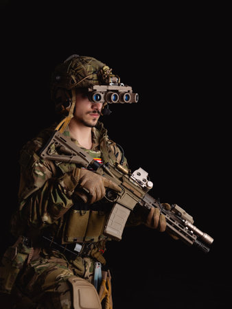 Delta Force soldier, US army special forces. Combat application group, Army compartmented element operator - Tier 1. Portrait on a black backdrop with rifle and night vision.の写真素材