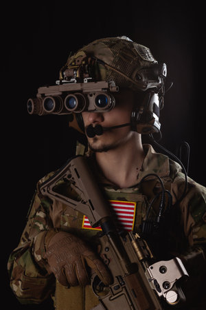 Delta Force soldier, US army special forces. Combat application group, Army compartmented element operator - Tier 1. Portrait on a black backdrop with rifle and night vision.
