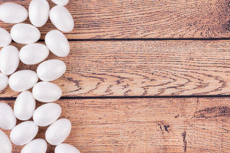 Easter eggs on wooden backdrop, minimal flat lay holiday concept.の写真素材
