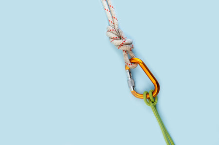 Orange carabiner. Equipment for climbing and mountaineering. Safety rope. Knot Prusik, clove hitch....