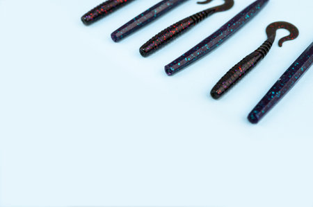 Bass fishing concept on the blue trendy background. Flat lay style. Fishing tackle, soft silicon lures, spinnerbait and wobblers.の写真素材