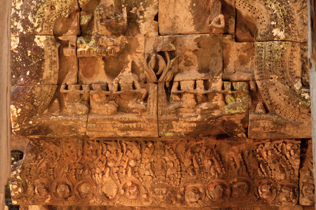 Ancient stone wall stucco sculpture on the antique carving wall at ancient temple Bayon templeの写真素材