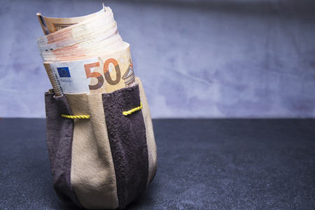 Old pouch stuffed with fifty euro banknotesの写真素材