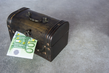 The half of hundred euro inserted in the chest boxの写真素材
