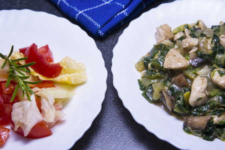 Chicken meat with mushroom and spinach sauce with saladの写真素材