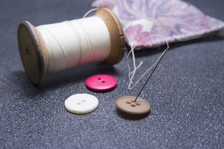 Needle in the button with old threadの写真素材