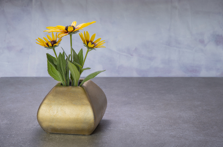 Yelow echinocea in the vase on the table on grungy backgroundの写真素材