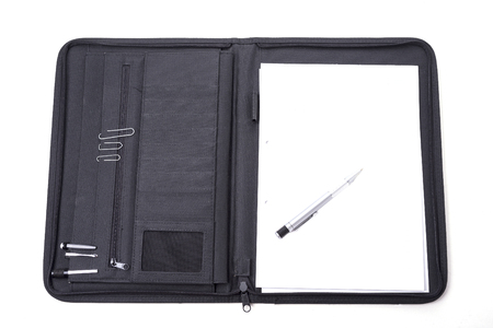 Open notepad carrying case with the pen on wthite backgroundの写真素材