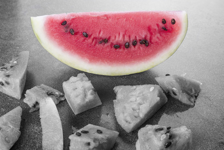 Black and white watermelon pieces on the board with color sliceの写真素材