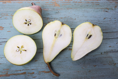 Sweet pears fruit cut in half in the old grungy backgroundの写真素材