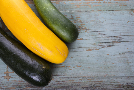 Different color vegetable zucchini on old grungy topの写真素材