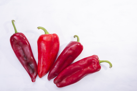 Four red peppers as a vegetable on white backgroundの写真素材
