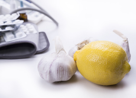 Closeup of garlic and lemon versus drugs and pillsの写真素材