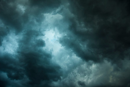 Dark sky with black clouds brings storm rain