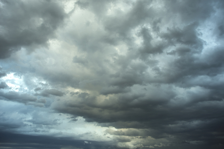 Dark sky with black clouds brings storm rainの写真素材