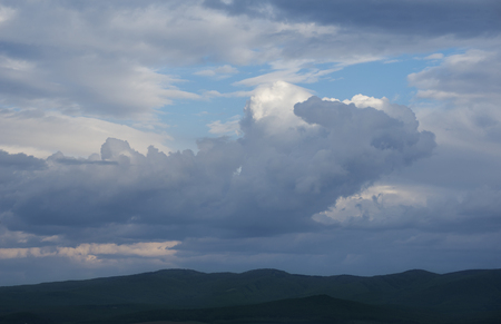 Dark dramatic landscape stormy sky over fieldの写真素材