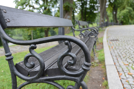 Old metal vintage benches with wood in raw paint in blackの写真素材