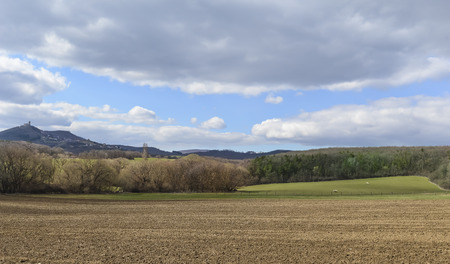 Dark clouds over the field and trees. Sky and field in the spring.の写真素材