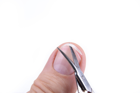Caucasian male hand showing nails  and cut them.の写真素材