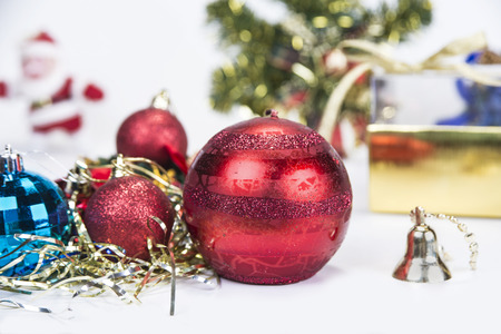 Christmas background with decorations  bells, ribbon and balls on white.の写真素材