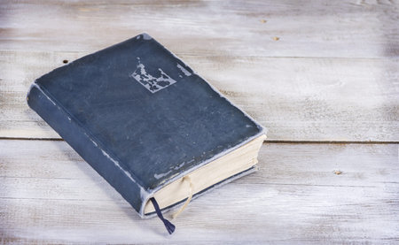 Old blue closed vintage book on wooden grunge background