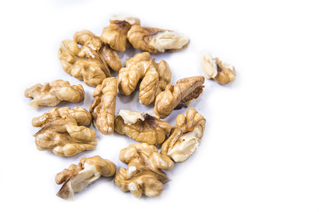 Fresh cleaned walnuts kernels on the white backgroundの写真素材