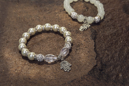Pearl bracelet custom jewelry on the wood or stone background