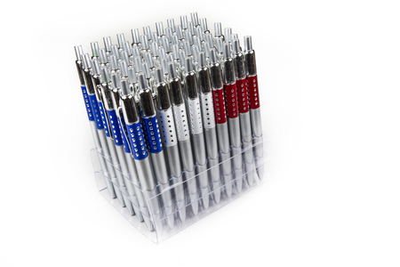 New pens in holder in rows on white backgroundの写真素材