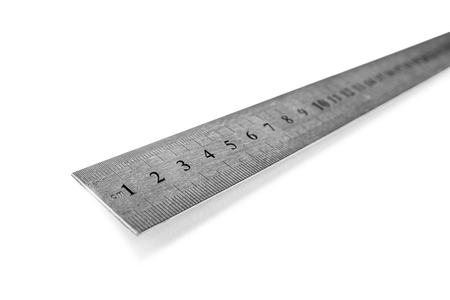 Metal ruler in centimeters or inches. Measuring tool on the white backgroundの写真素材