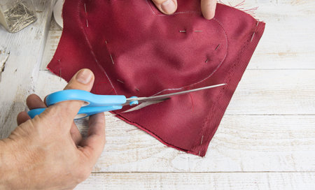 Step by step how to make heart from red satin textile. Valentine's day concept.