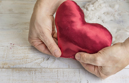 Step by step how to make heart from red satin textile. Valentine's day concept.の写真素材