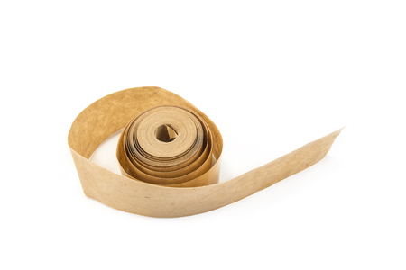 Brown roll of old paper tape for office  on the whiteの写真素材