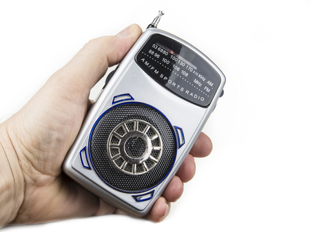Old and small transistor radio on battery on the whiteの写真素材
