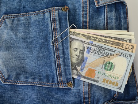 US dollars in the back pocket of blue jeansの写真素材