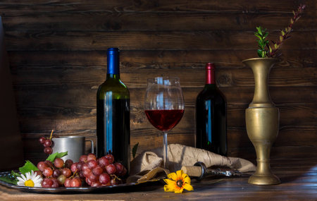 Still life with retro cup and vase and grapes and  red wineの写真素材