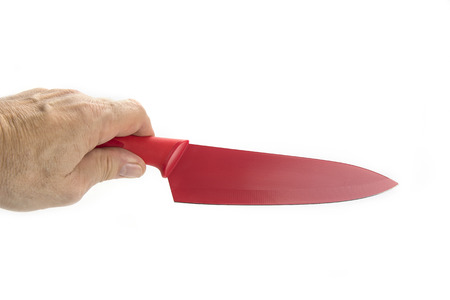 Quality kitchen sharp knife in red on the white in handの写真素材