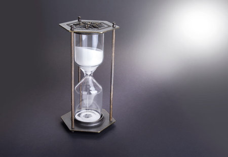Hourglass as time passing concept for business deadline, urgency and running out of time.